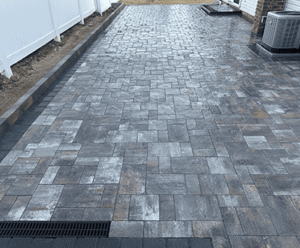 Paved outdoor area featuring gray masonry stones, showcasing Soft Wind Landscape & Masonry's design expertise in custom outdoor projects in New York.