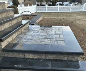 Masonry patio and steps featuring intricate stone patterns, showcasing Soft Wind Landscape & Masonry's expertise in outdoor design.